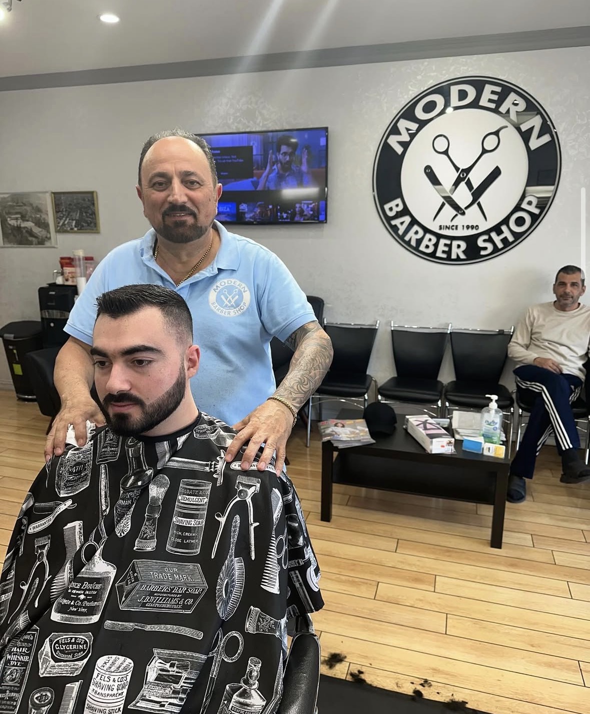 Barber finishing a clean tapered haircut and beard trim