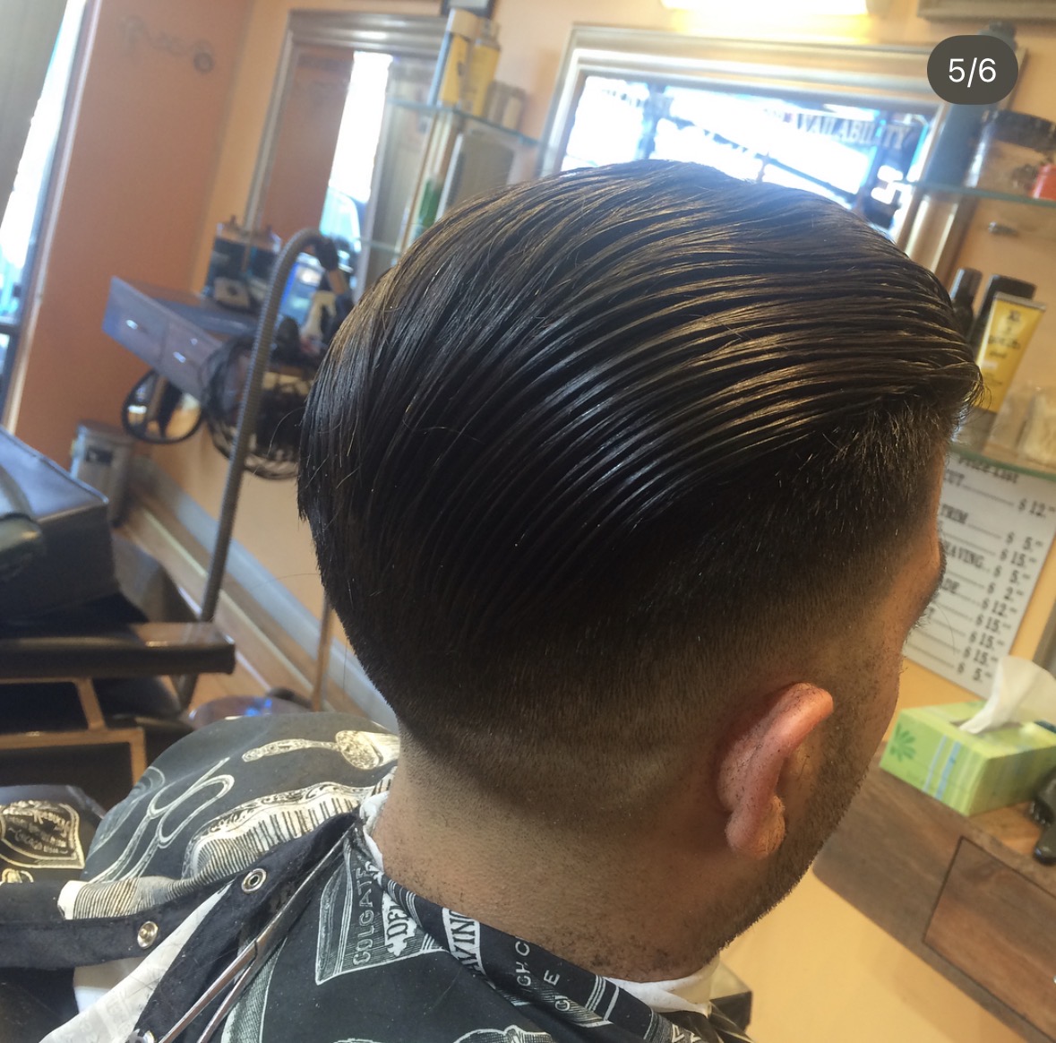 Slicked-back pompadour with low fade finish
